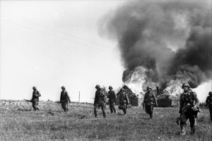 German troops advance past a burning farmhouse somewhere in Russia. During the opening months of Operation Barbarossa, the Nazi juggernaut was victorious on all fronts, encircling Red Army formations and capturing thousands of prisoners.
