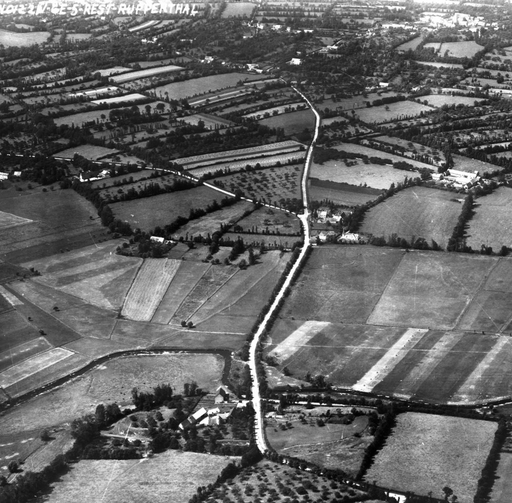 The La Fiere bridge is visible in the lower center portion of this aerial photograph, a few miles west of the town of Ste. Mere-Eglise. It stands just to the right of La Fiere Manor, the scene of fierce fighting during the early phase of the Normandy operation as American paratroopers retained control of the span. The large fields in the center of the photo were flooded by the Germans prior to D-Day, and they were virtually impassable in June 1944.