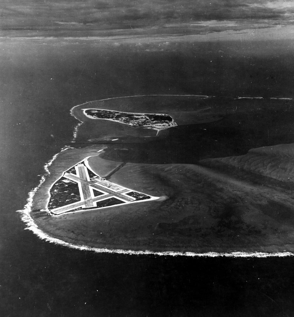 In this November 1942 aerial photograph, Midway Atoll and its surrounding coral reef are visible. Eastern Island with its vital airstrip is shown in the foreground, while Sand Island is seen in the distance.