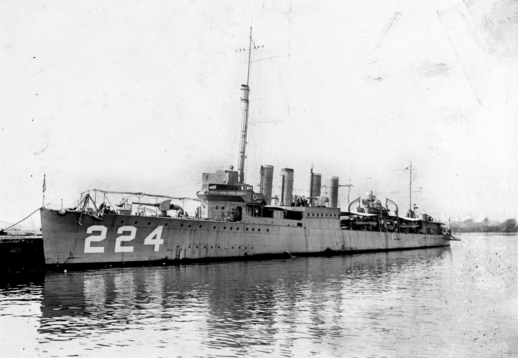 Sporting her original four stacks, the destroyer USS Stewart lies moored in harbor in this pre-World War II photograph.  