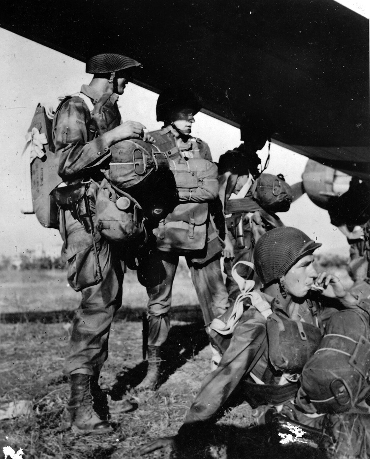 Troopers of Frederick’s First Airborne Task Force check their gear and stand by to board air transports that will take them over drop zones in southern France. When General Frederick went in with his airborne soldiers, he was making only his second jump.