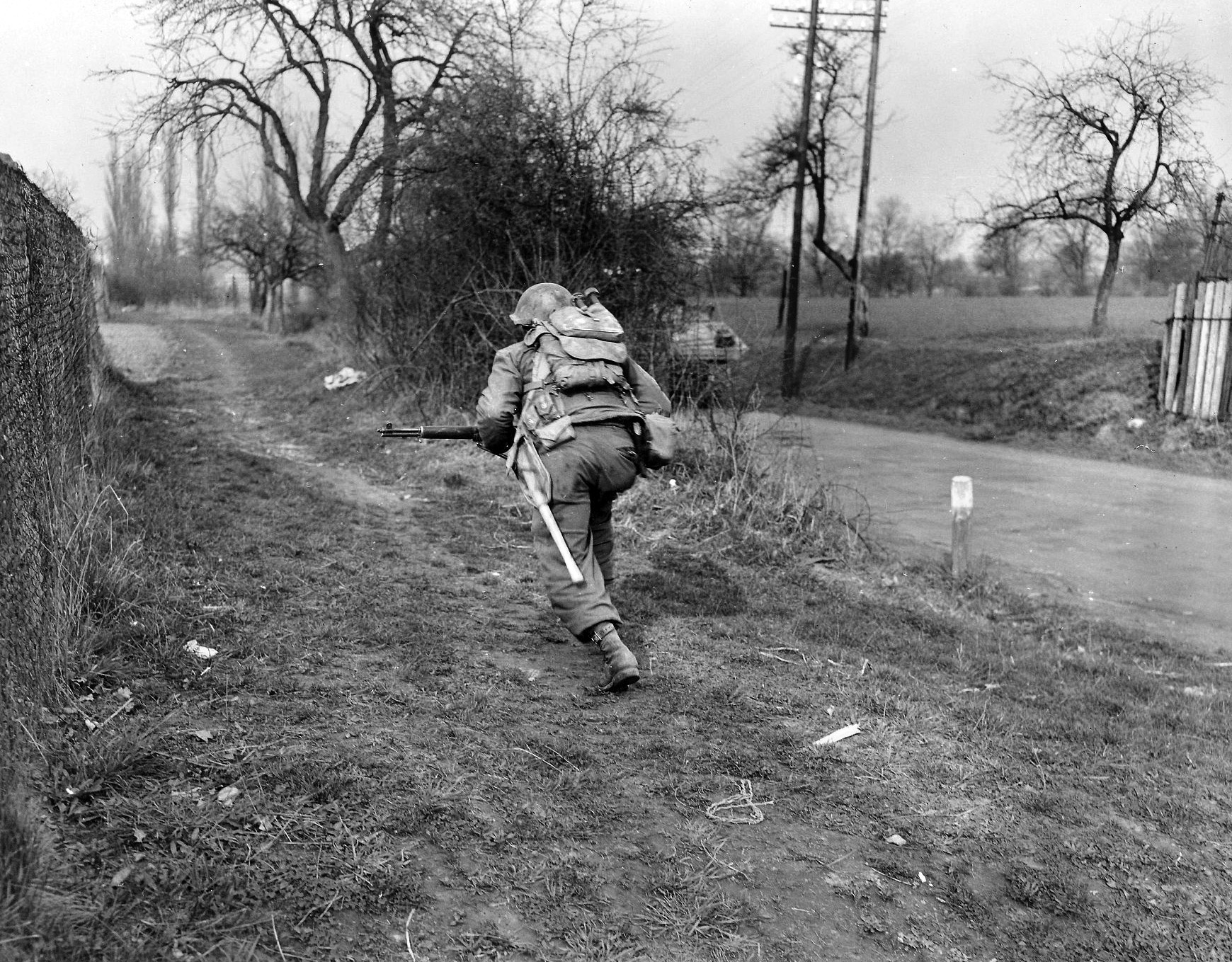 A 45th Division soldier scurries for cover on the outskirts of Aschaffenburg, Germany, in this image taken on March 28, 1945. Six days later, General Frederick, the division commander, demanded the surrender of Aschaffenburg, and the city was occupied after a bitter fight.