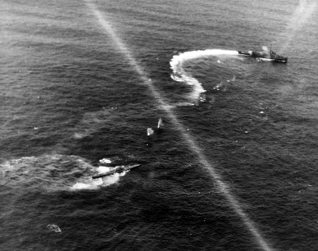 In this combat photo taken on April 9, 1944, the German submarine U-515 is shown under attack by the destroyer escorts USS Pope, Chatelain, Pillsbury, and Flaherty while aircraft of Squadron VC-58 from the escort carrier USS Guadalcanal join in. U-515 was commanded by Lt. Commander Werner Henke, an ace who had sunk 25 Allied ships. Henke and 43 crewmen survived the sinking of U-515 and were rescued.