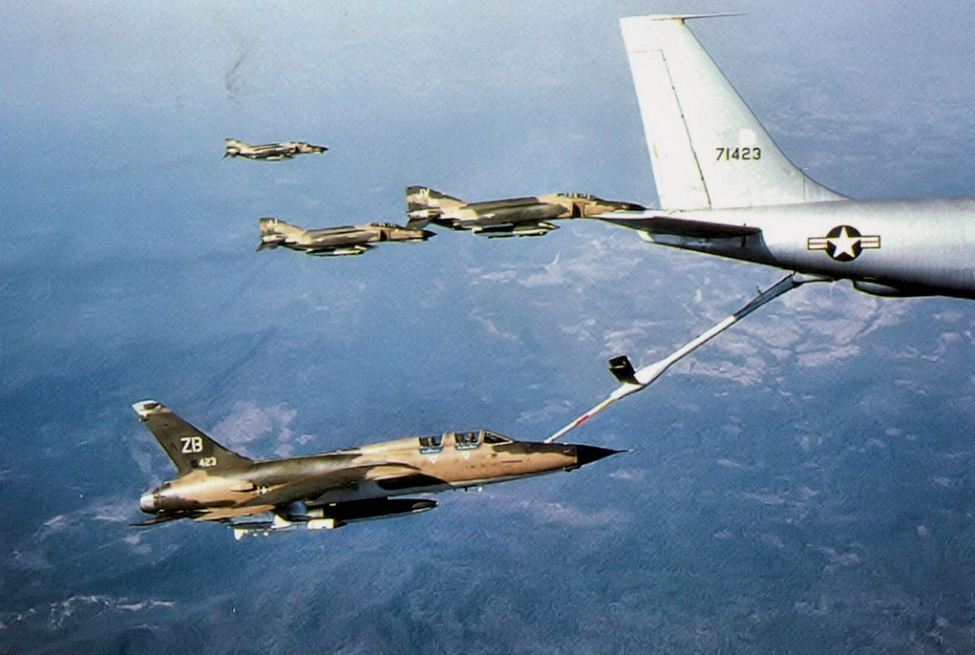 An Air Force KC-135 Stratotanker refuels a flight of F-105 Thunderchiefs on their way to strike targets in North Vietnam. Refueling operations in the Vietnam War peaked during Operation Rolling Thunder.