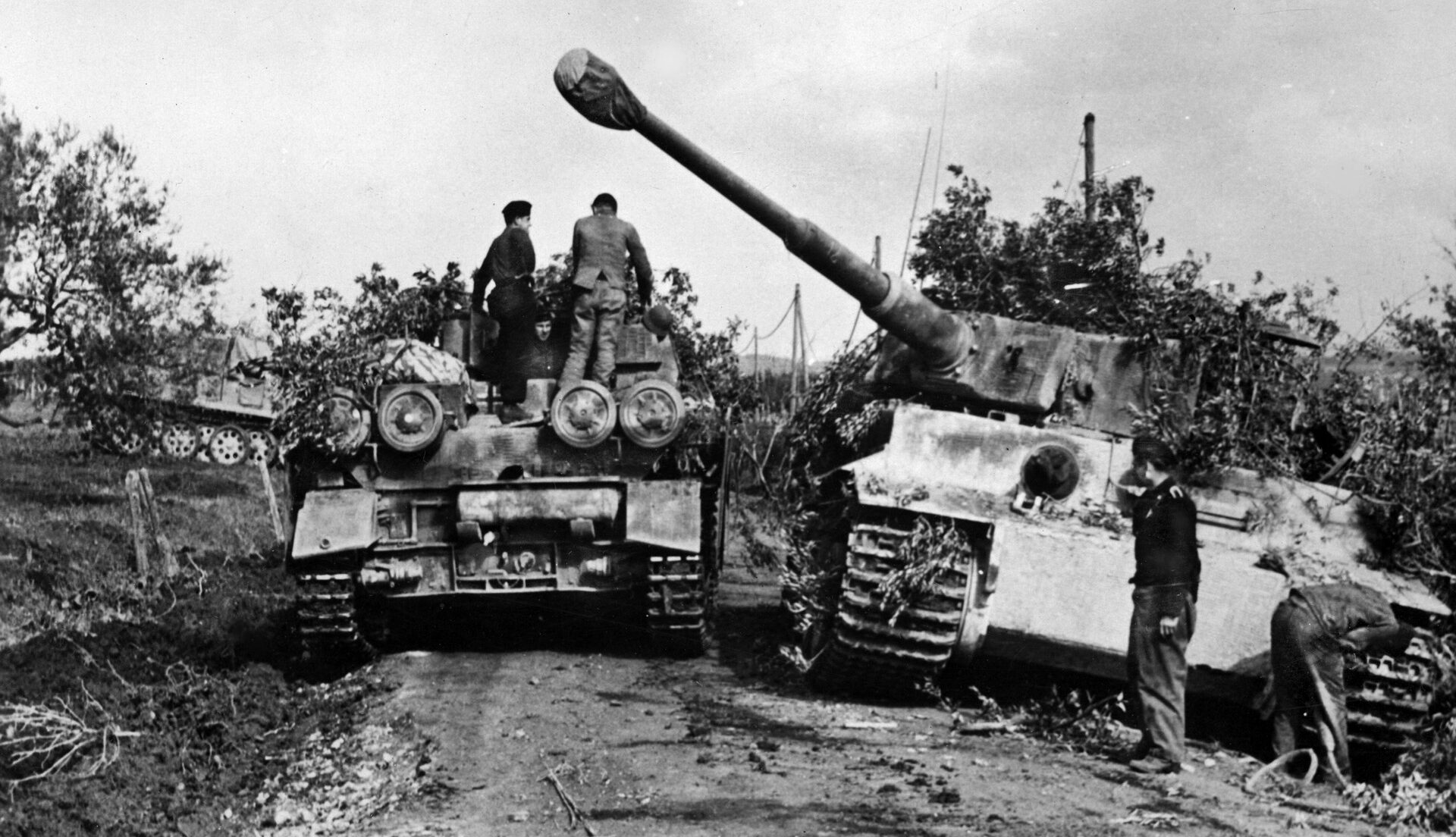 A German kampfgruppe uses camouflage in an attempt to conceal itself from Allied aircraft. German armor assets included the formidable Panzerkampfwagen VI Tiger I (at right) with its deadly 88mm gun. 
