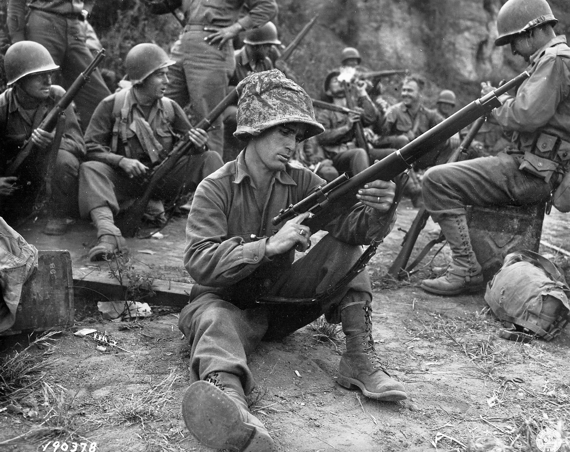 An American soldier readies his Springfield M1903A4 sniper rifle for action. 