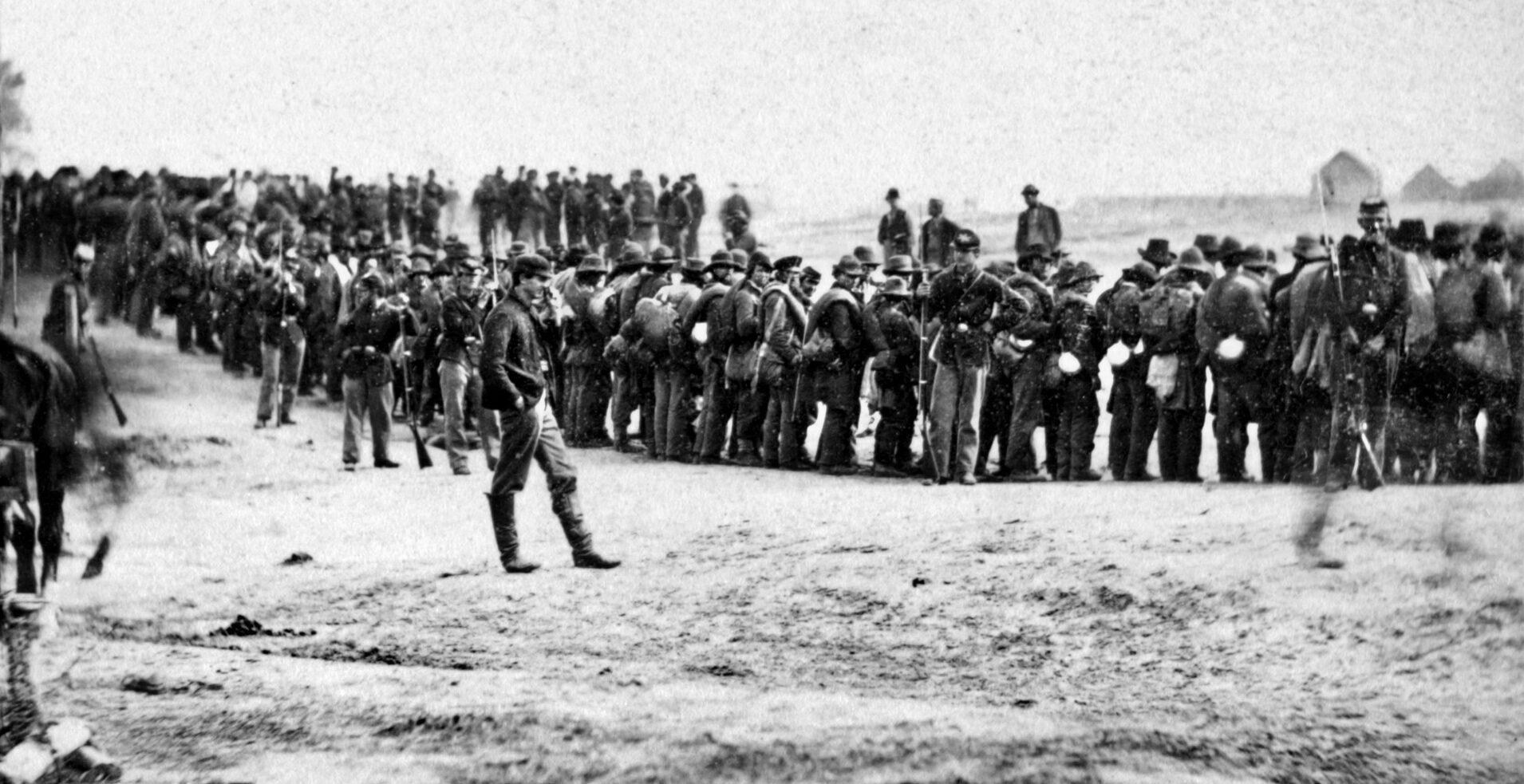 Carrying their knapsacks and bedrolls, Maj. Gen. George Pickett's defeated Confederate troops are marched into captivity after their defeat at Five Forks.