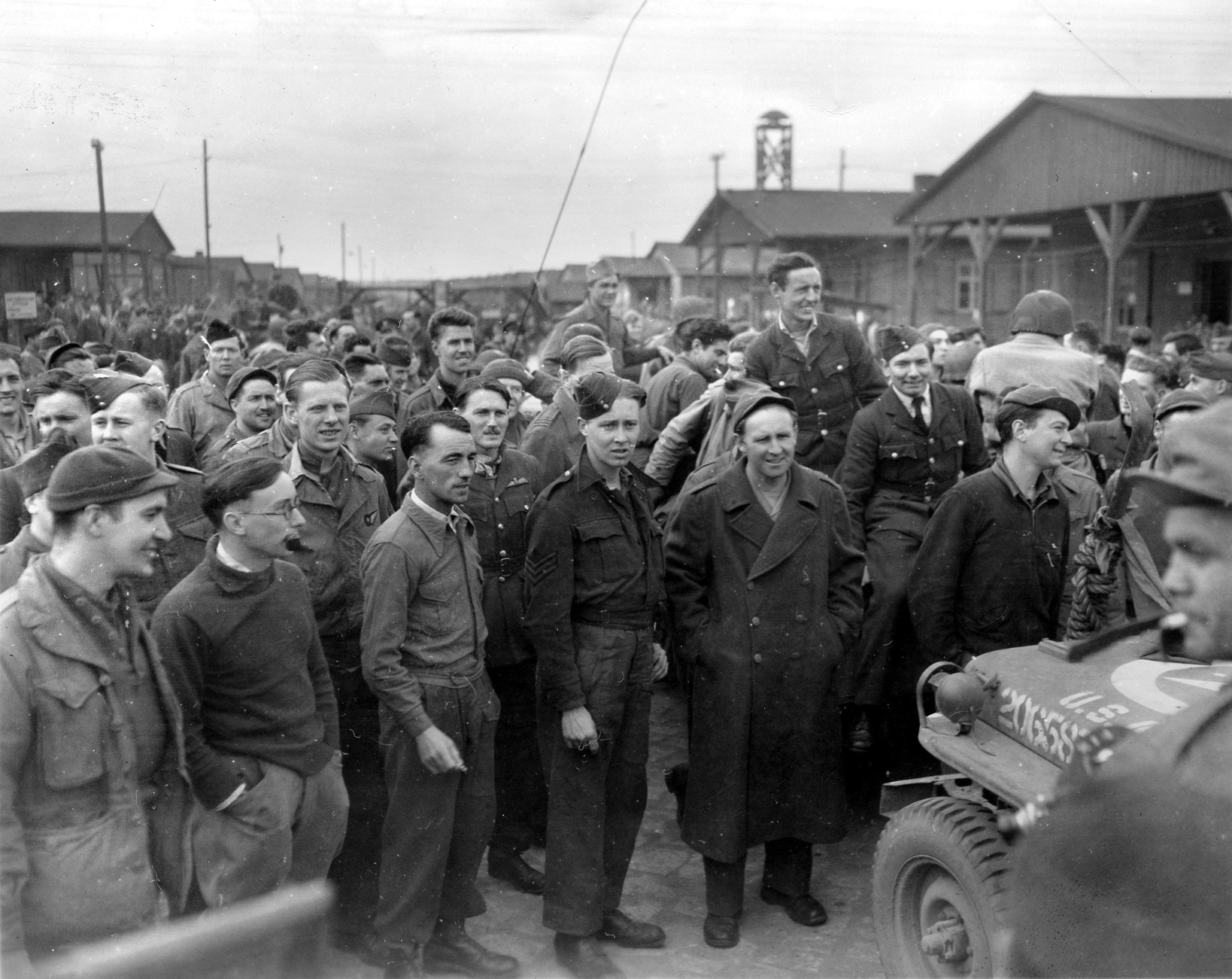 Liberated from a German prison camp in the spring of 1945, American and British soldiers relish their first moments of freedom in months. Medical treatment, ample food, and the long trek home awaited them after a long period of privation.