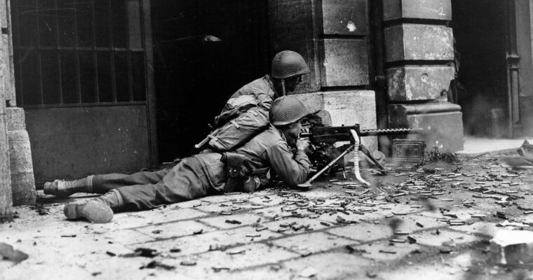 The best place to be in an urban battle was next to the buildings where it was possible to find a degree of cover from enemy fire. An American machine-gun team belonging to the 26th Infantry Regiment engages the enemy in mid-October.