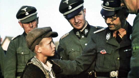 Reichsfuhrer SS Heinrich Himmler, founder of the Lebensborn Program, talks with a young Ukrainian boy. Many children were essentially kidnapped from occupied countries and given to German parents.