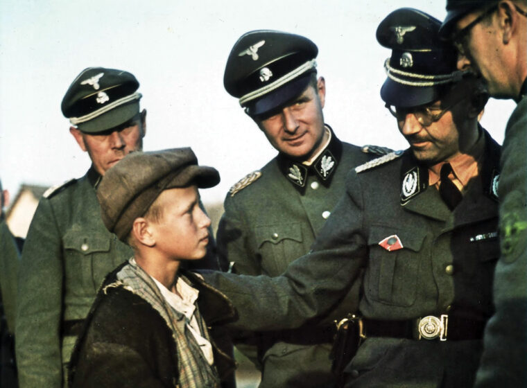 Reichsfuhrer SS Heinrich Himmler, founder of the Lebensborn Program, talks with a young Ukrainian boy. Many children were essentially kidnapped from occupied countries and given to German parents.