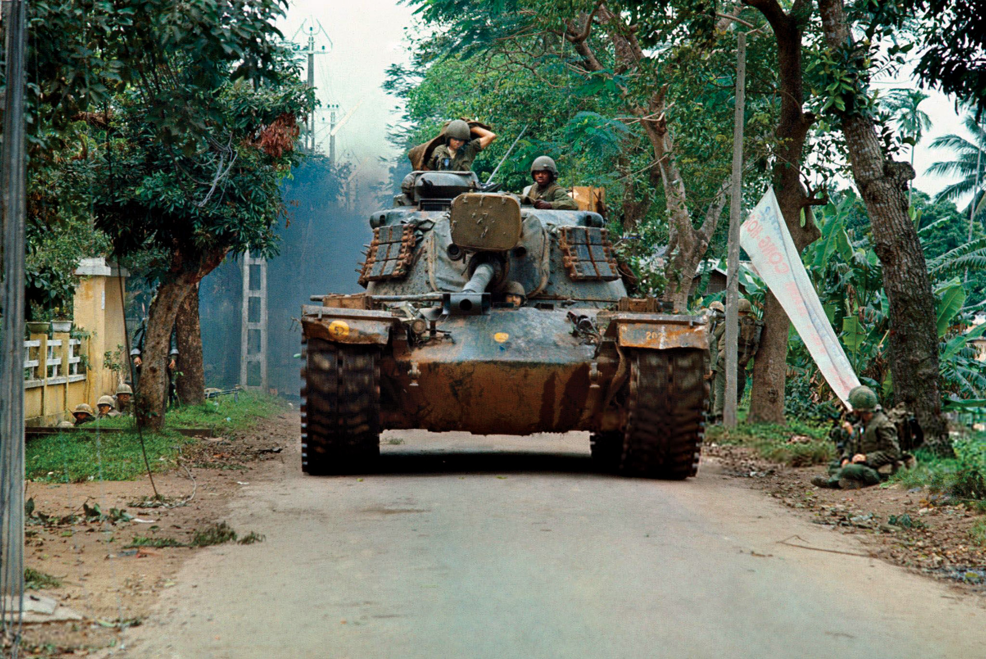 An M48A3 Patton tank with its 90mm gun moves down a street in Hanoi. Tank crews drew heavy fire and suffered substantial casualties as a result. 
