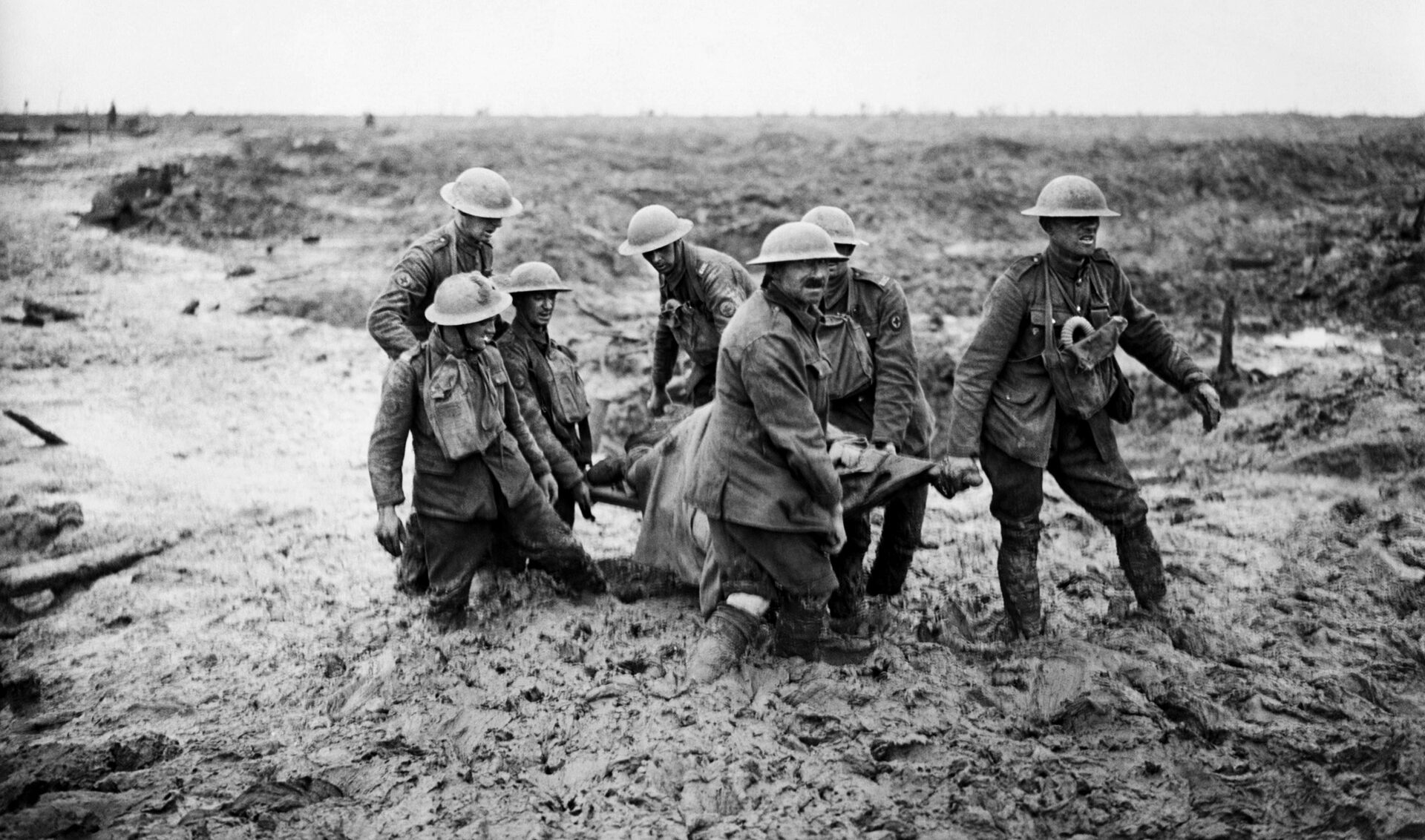 British soldiers struggled through the mud as they carry a wounded comrade to safety near Pilckem Ridge during the second day of the attack. Heavy rains in early August turned the ground into a muddy morass that hampered the offensive. 