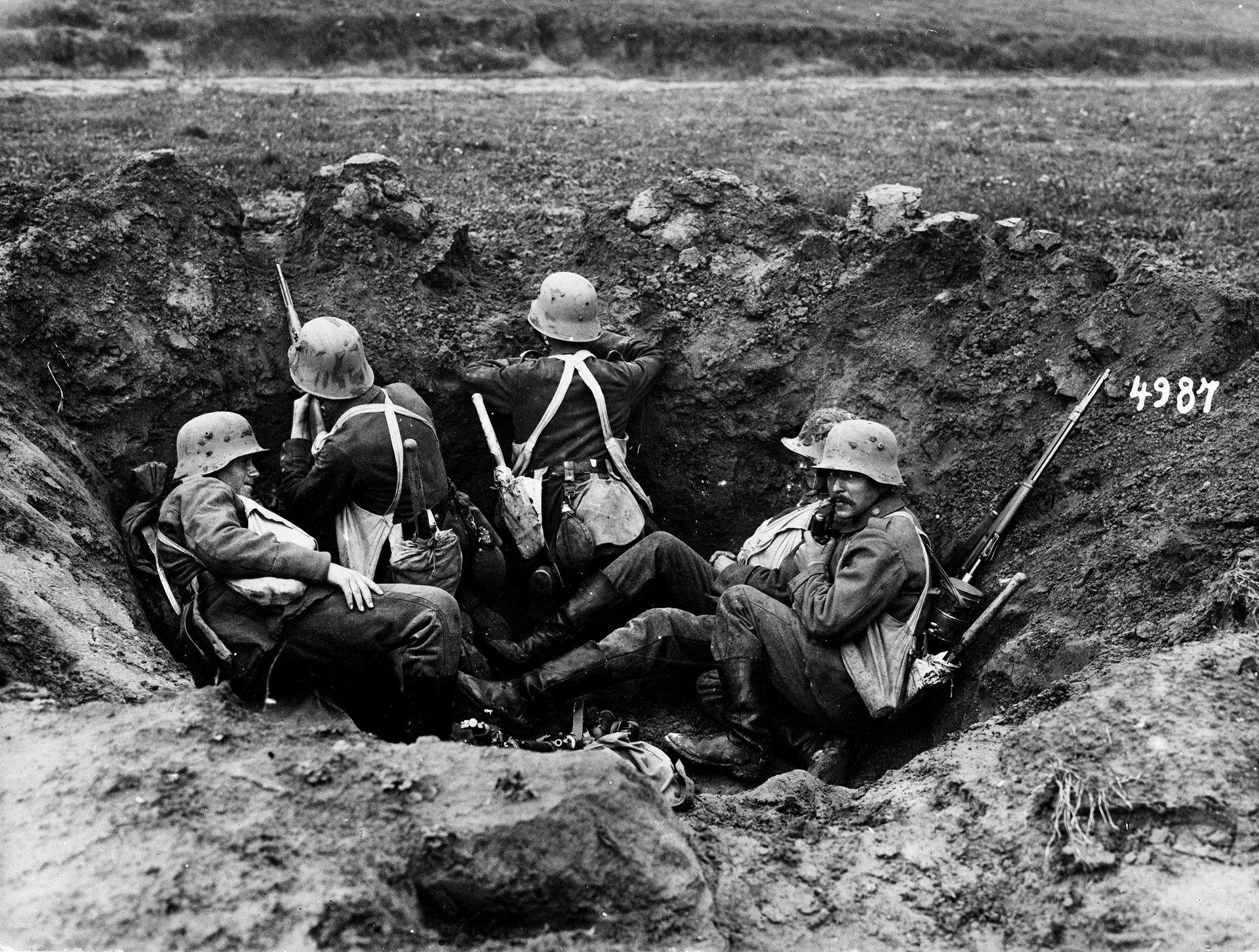 Germans take cover in a shell crater during a counterattack. The Germans held troops in reserve for counterattacks that negated the British army's incremental advances.