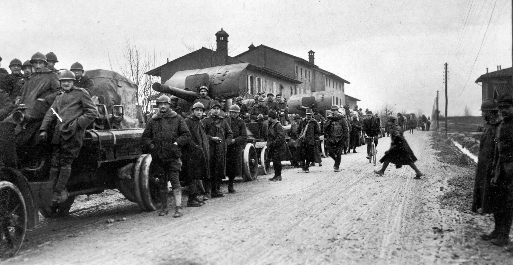 A column of Italian anti-aircraft gun trucks heads to the rear during the long Italian retreat at Caporetto. The Italian army was on the brink of collapse when British and French troops arrived to  stabilize the situation.