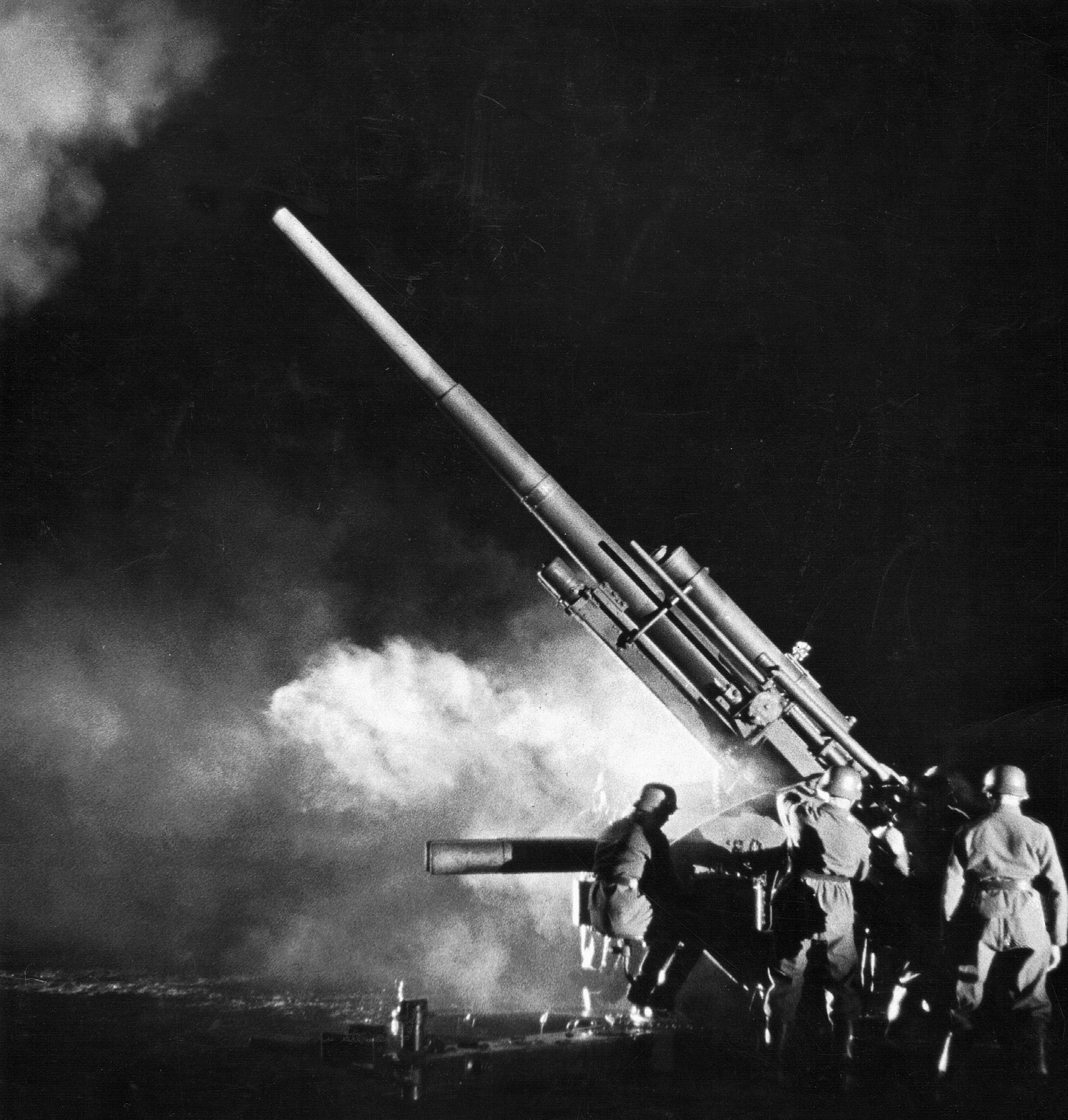 An 88mm antiaircraft gun fires during a night raid by Royal Air Force bombers.  The 88mm gun was a versatile weapon, gaining a fearsome reputation in the anti-tank role.