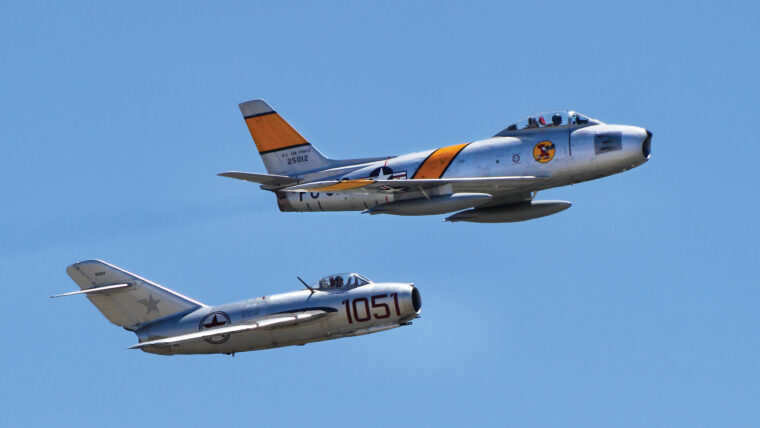 A Mig-15 follows an F-86F Sabre at an air show in California in 2014. These two aircraft ushered in the age of jet fighter warfare during the Korean War.