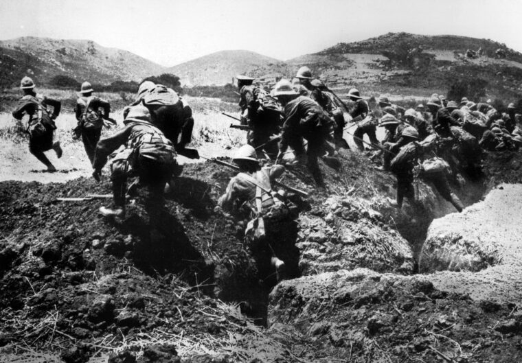 Marines of the British Royal Naval Division go over the top in an assault against Ottoman positions on the strategic high ground of Achi Baba at the base of the Gallipoli Peninsula.