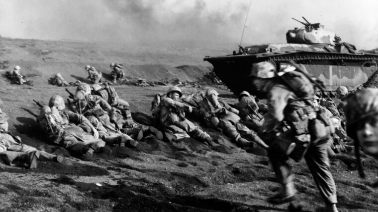 U.S. Marines cautiously advance after landing on February 19, 1945. U.S. forces needed the tiny island as a stepping stone for a possible invasion of Japan.