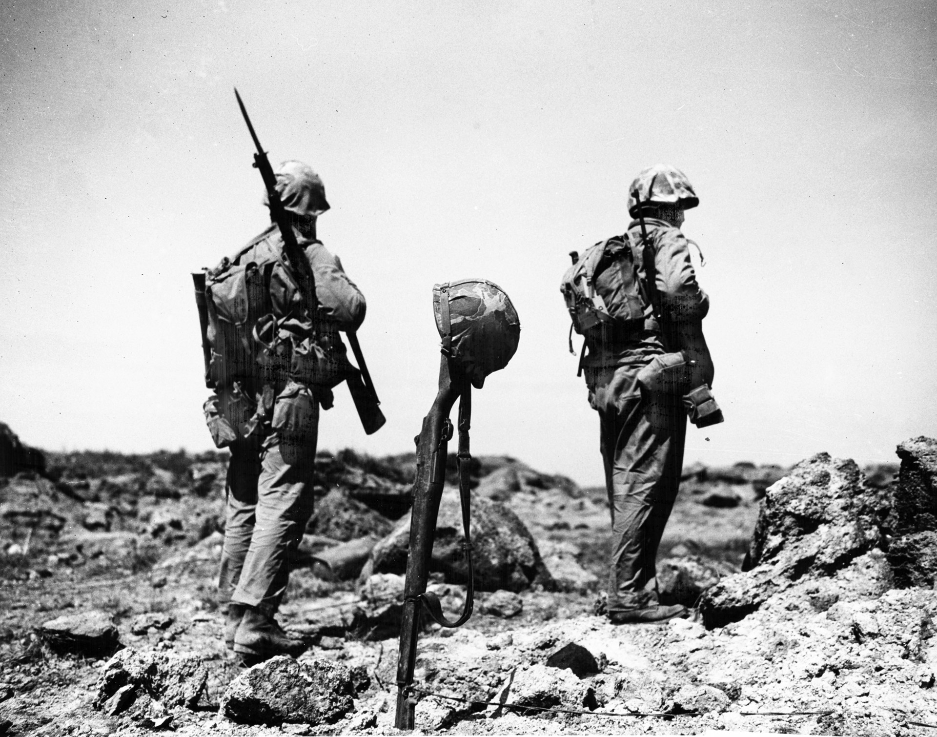 Marines pass the grave of a fellow warrior who was buried at the spot where he was killed. Iwo Jima was the only battle in the Pacific War in which U.S. casualties outstripped those of the Japanese.