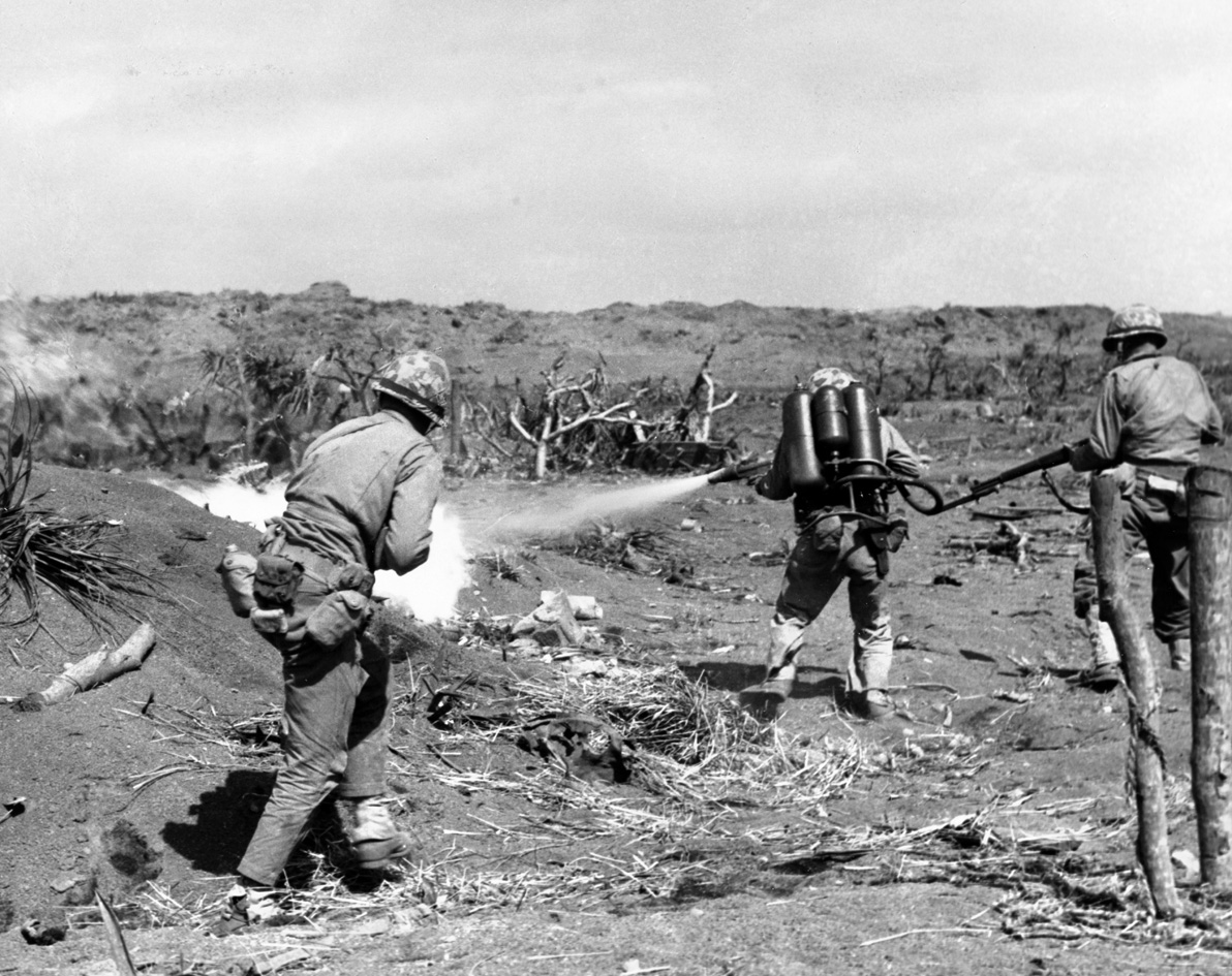 A Marine on Iwo Jima armed with an M2 flame thrower goes into action against a Japanese position. The weapon could shoot a stream of jellied gasoline up to 60 yards. 