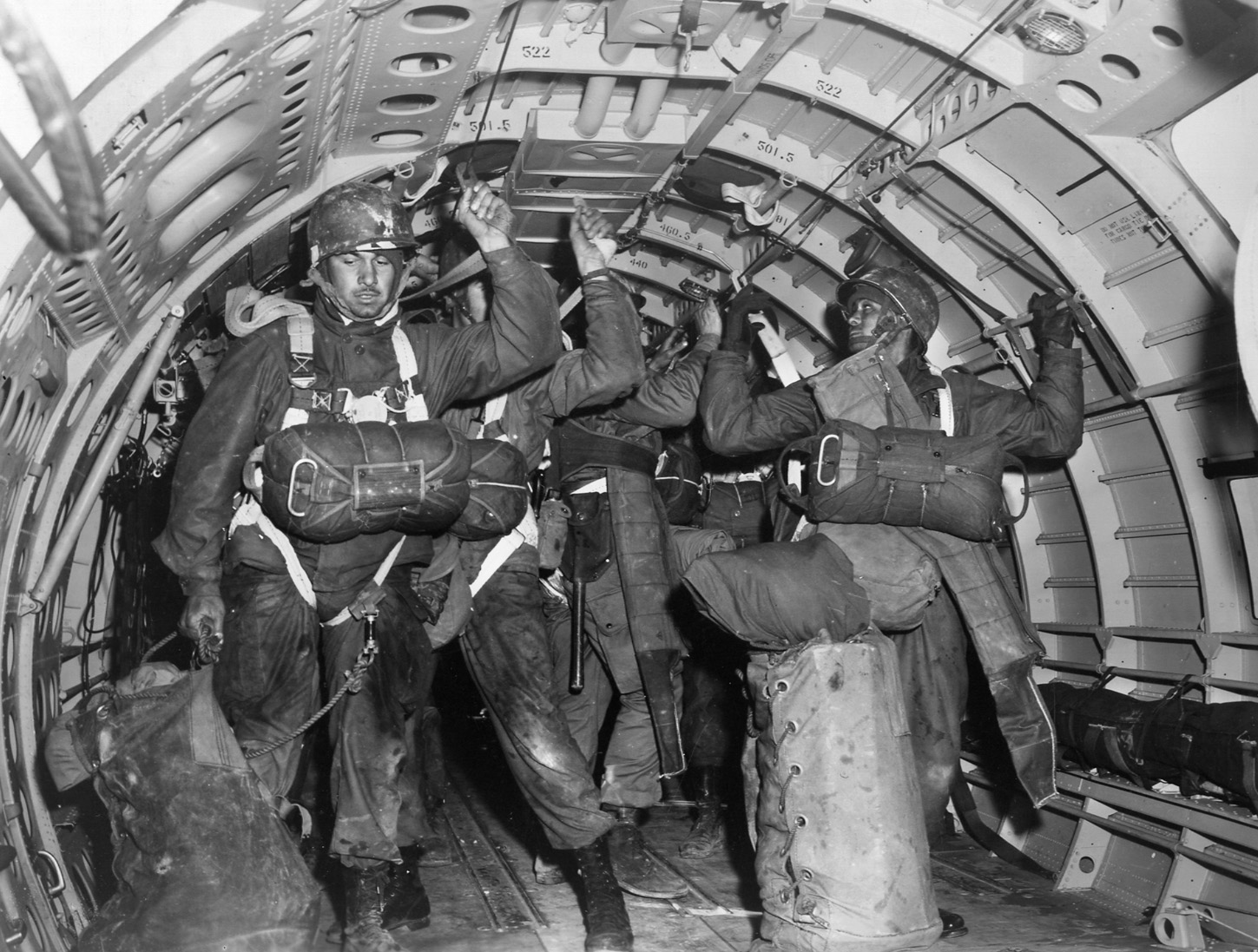 Stand up! Hook up! Paratroopers of the 82nd “All American” Airborne Division prepare to jump from a transport aircraft during a training exercise.