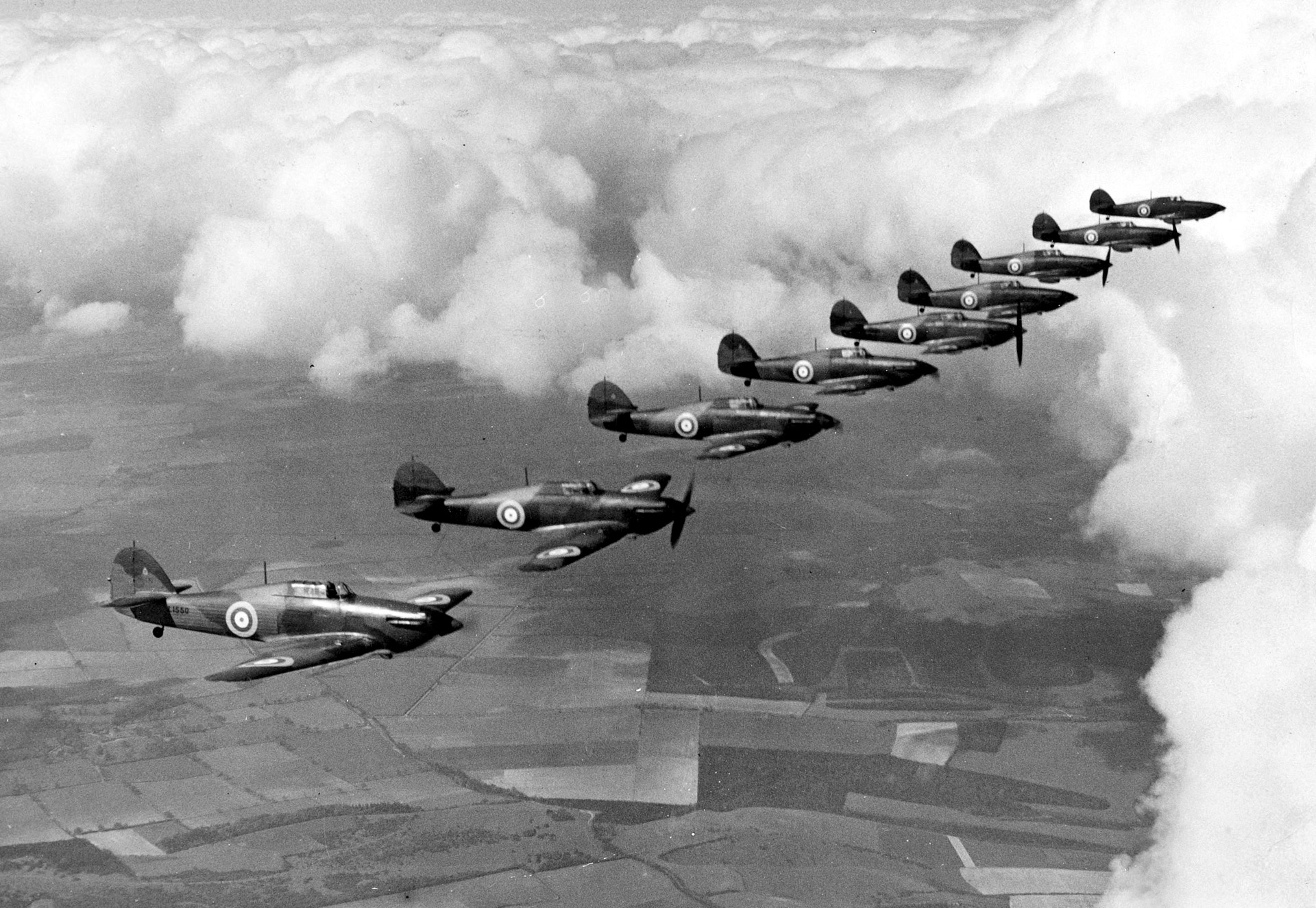 Flying wingtip-to-wingtip, a formation of RAF Hawker Hurricanes from No. 111 Squadron glides above the English countryside. While the Spitfire is more famous today, the Hurricane was the first monoplane fighter to exceed 300 miles per hour and accounted for many “kills" against the Luftwaffe.