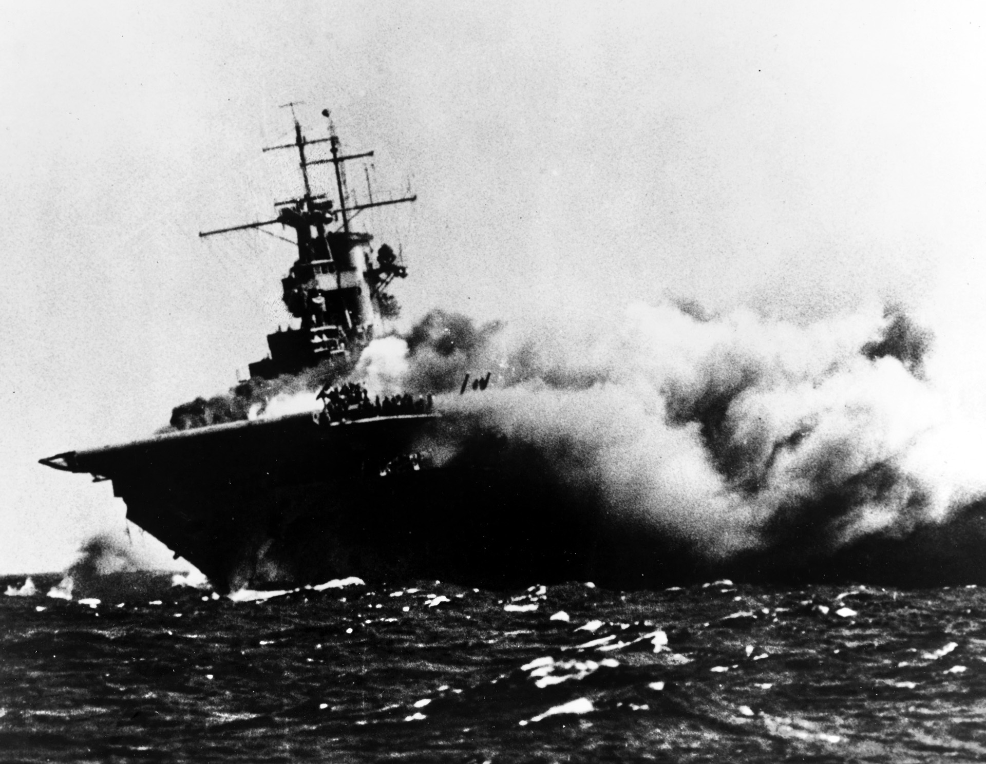 Sailors can be seen preparing to abandon ship at the bow of Wasp as she burns fiercely on September 15, 1942. A total of 171 officers and 1,798 enlisted men survived, while 25 officers and 150 men lost their lives.