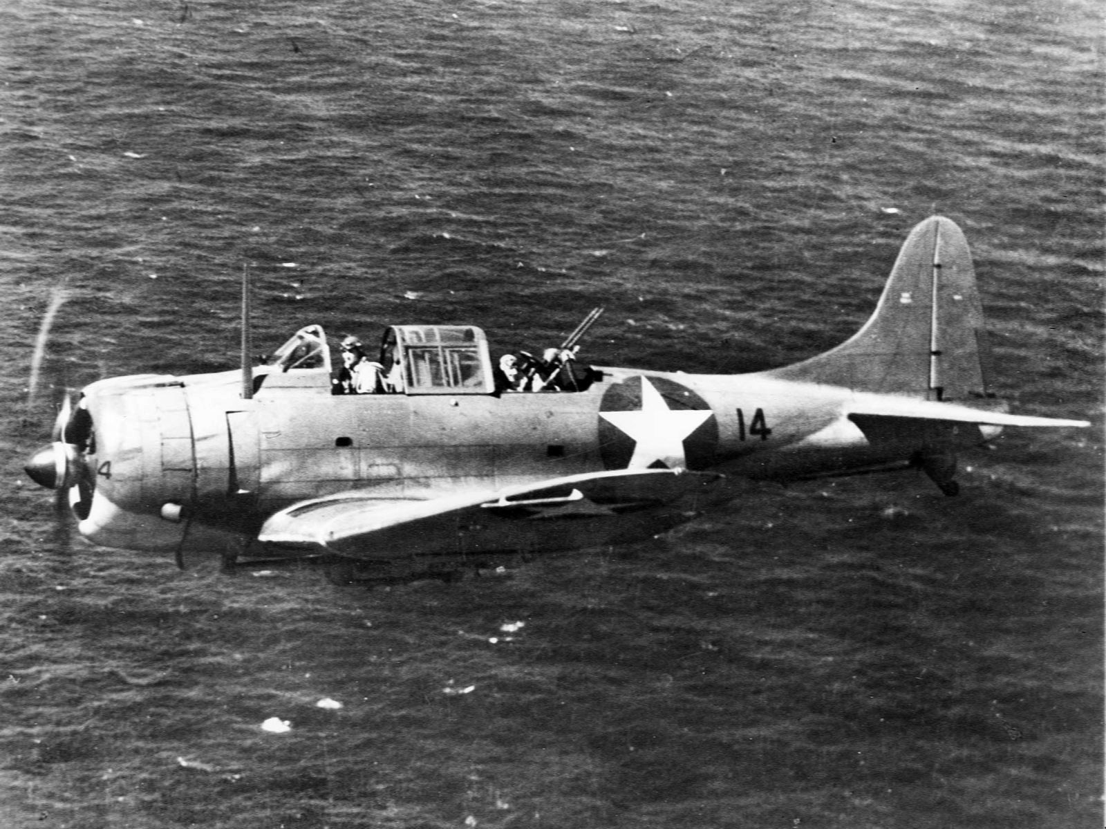 An SBD Dauntless scout bomber from Wasp flies patrol near Guadalcanal during the invasion there, August 1942.