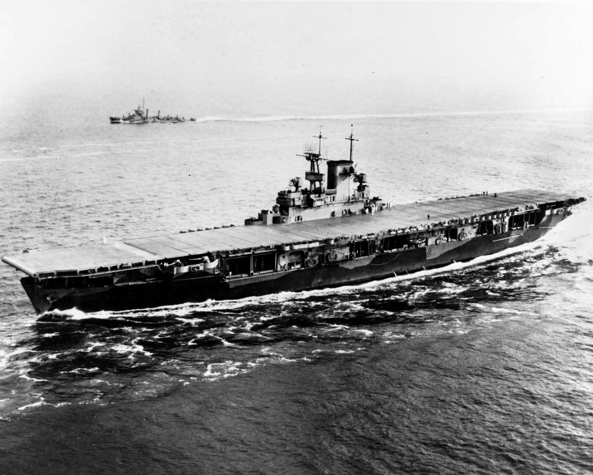 With a destroyer escort and her flight deck devoid of planes, Wasp enters Hampton Roads, Virginia, May 26, 1942. She was returning from her Mediterranean duty. 