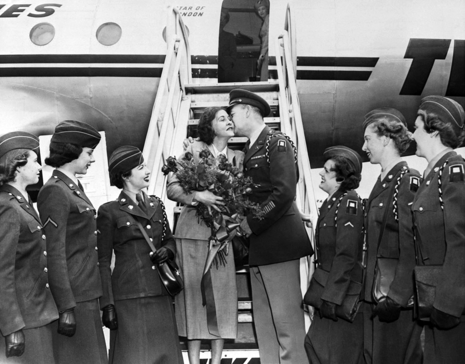 Phillips receives a bouquet of flowers and a warm greeting from Major Kenneth Boggs, who survived Japanese imprisonment with her help.