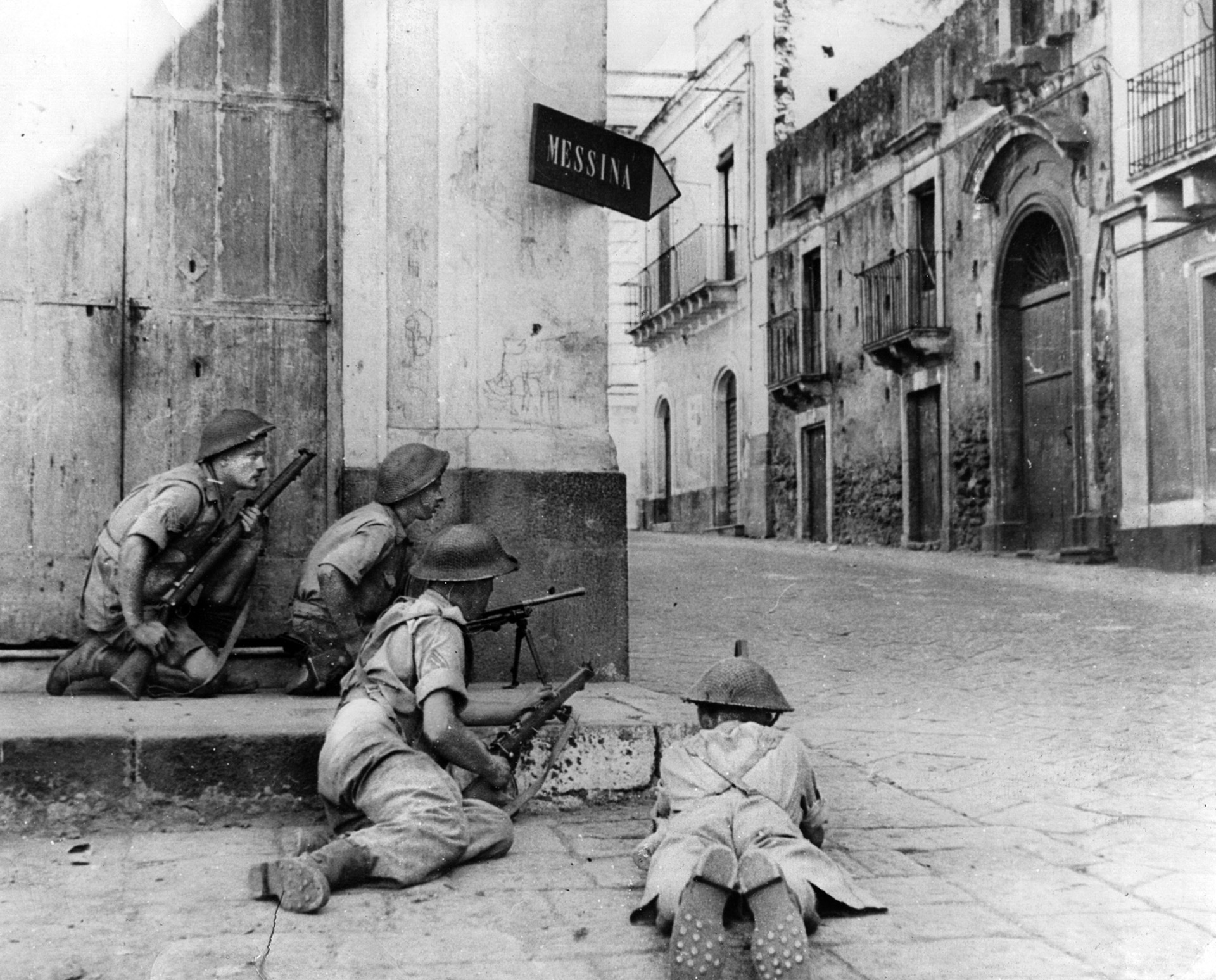 A British patrol takes up a position in a street in Acireale, northeast of Catania, near Mt. Etna. The British faced stubborn opposition during their drive to Messina. 