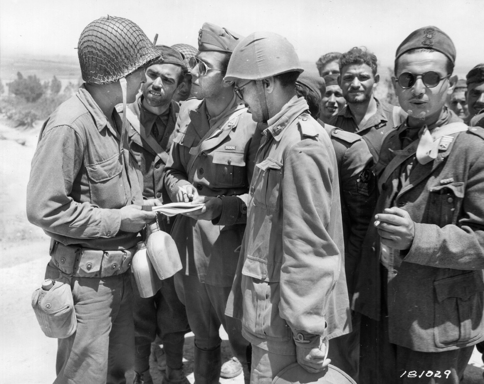 An Italian-speaking GI speaks with Italian prisoners who seem happy to be out of the war.