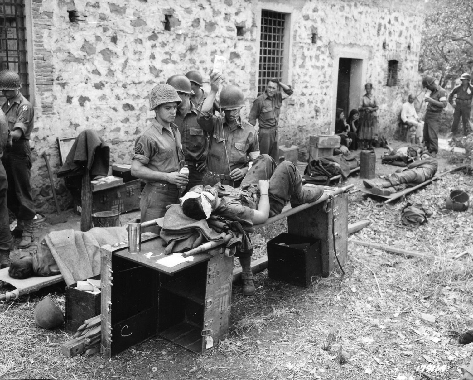 Medics of the 3rd Infantry Division attend to the wounded at an aid station in the town of Sant'Agata, between Palermo and Messina, August 9, 1943.