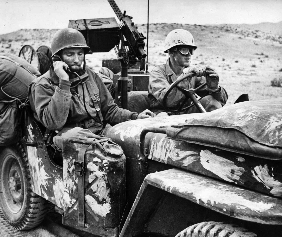U.S. soldiers travelling by jeep pause near El Guettar to report on potential enemy targets. Company B’s attached reconnaissance platoon scouted ahead, followed by a heavy platoon. 