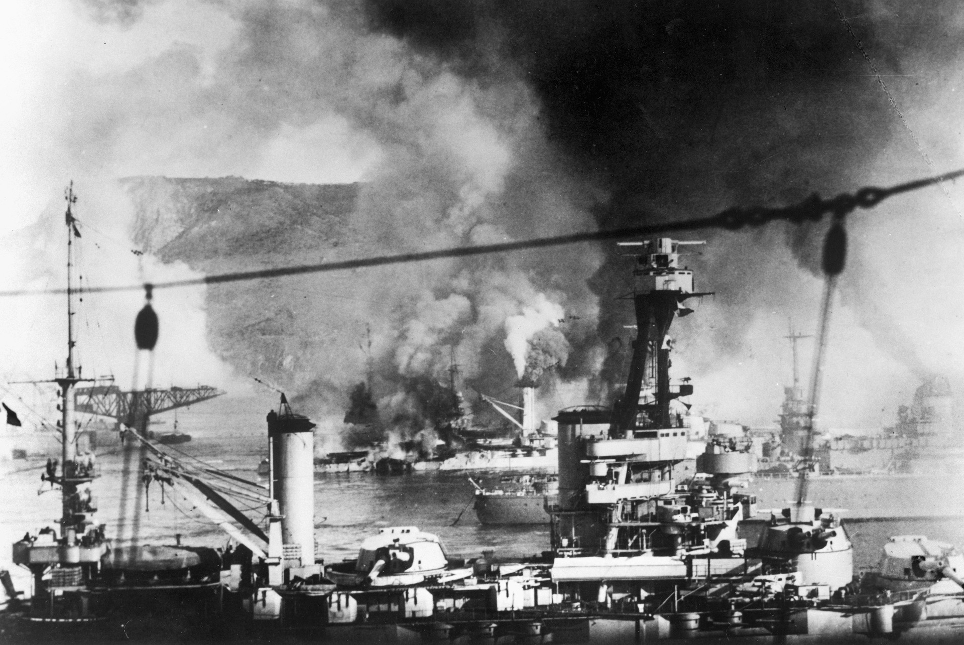  To keep it from falling into German hands, British Prime Minister Winston Churchill ordered the Royal Navy to bombard the formidable French fleet at Mers el-Kebir, near Oran, French Algeria. Here the fleet burns furiously on July 3, 1940. 