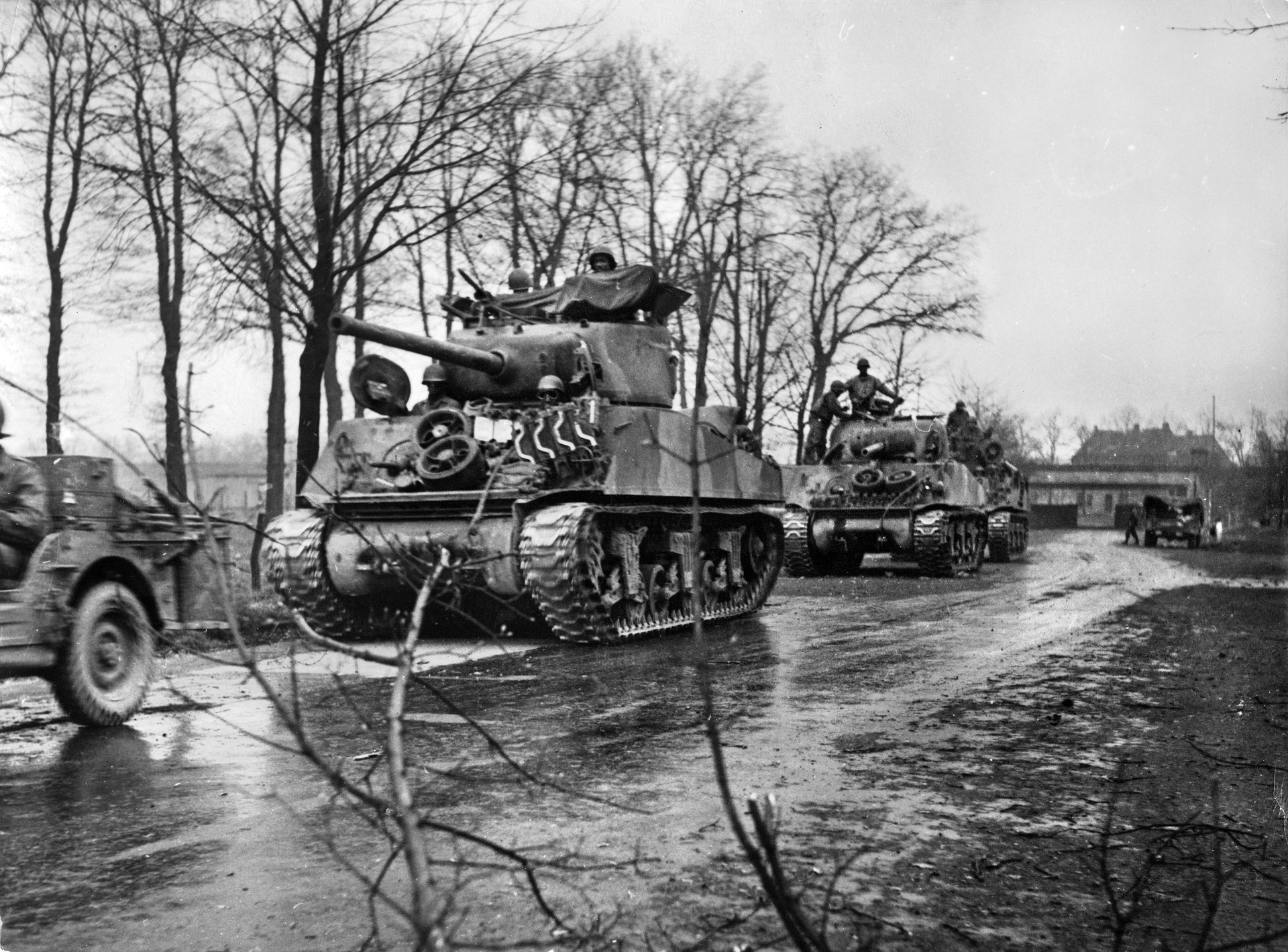 Three Sherman tanks of the African American 784th Tank Battalion line up on a road outside a village before going into action, December 1943. The 784th supported the 35th Infantry Division during Operation Grenade and helped to capture several towns in late February 1945.