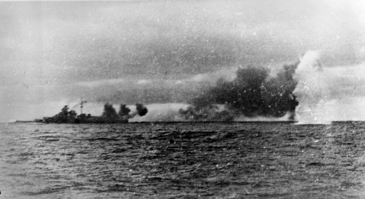 The photographer on Prinz Eugen captures the landing of a shell from Prince of Wales as it explodes in a harmless, watery plume (right), while Bismarck, at left, lobs shells toward the British ships. 