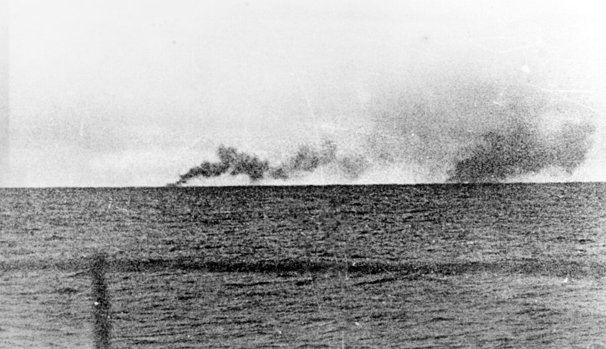 A plume of smoke at left marks where Prince of Wales turned to escape the range of the German ships. The smoke at right marks the spot where HMS Hood exploded and sank with almost all hands aboard; only three men survived. 