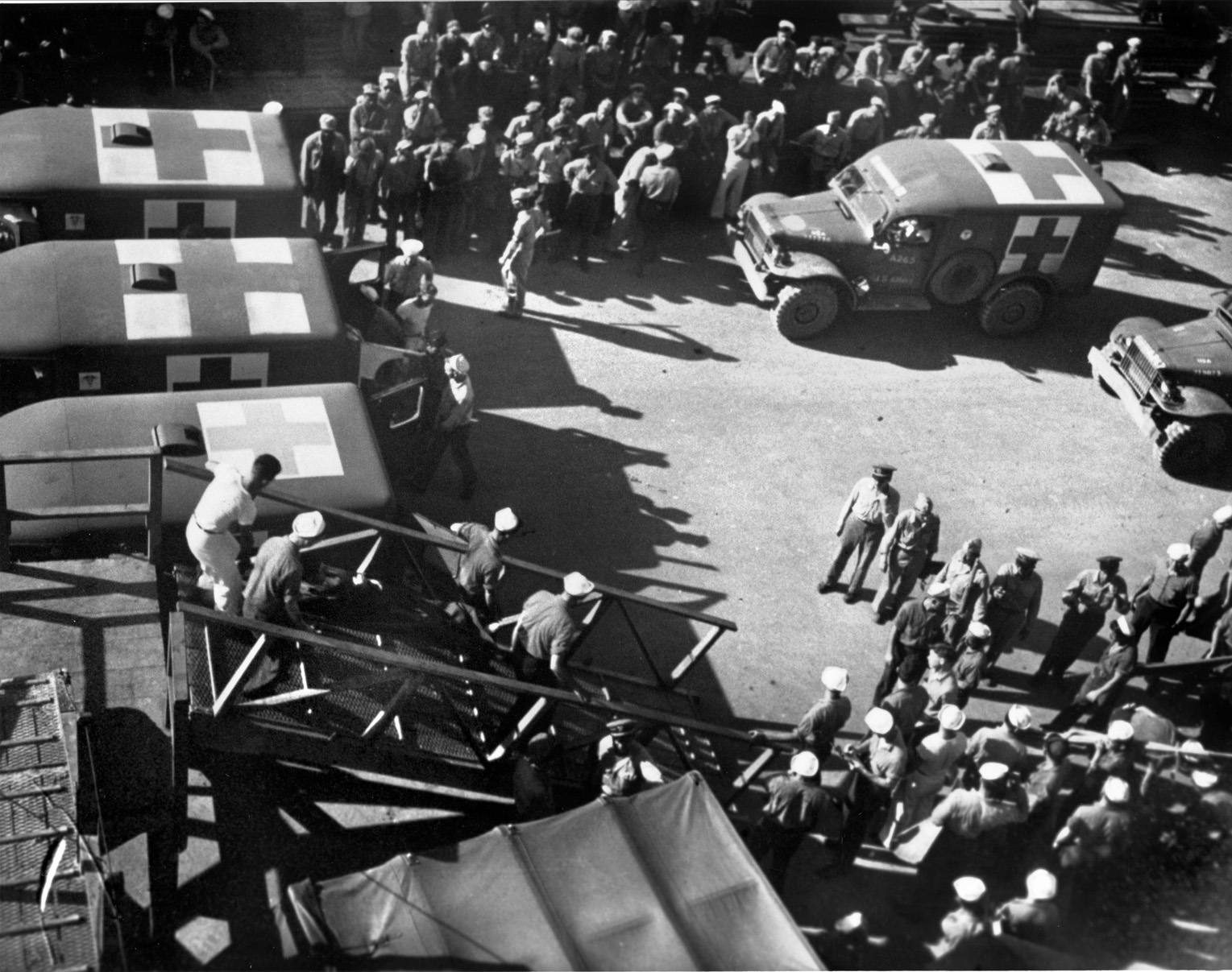 Paul Murphy was one of the injured and dehydrated survivors of the sinking. Here survivors are being brought ashore on Guam from the hospital ship USS Tranquility. Ambulances are standing by to transport them to local hospitals.