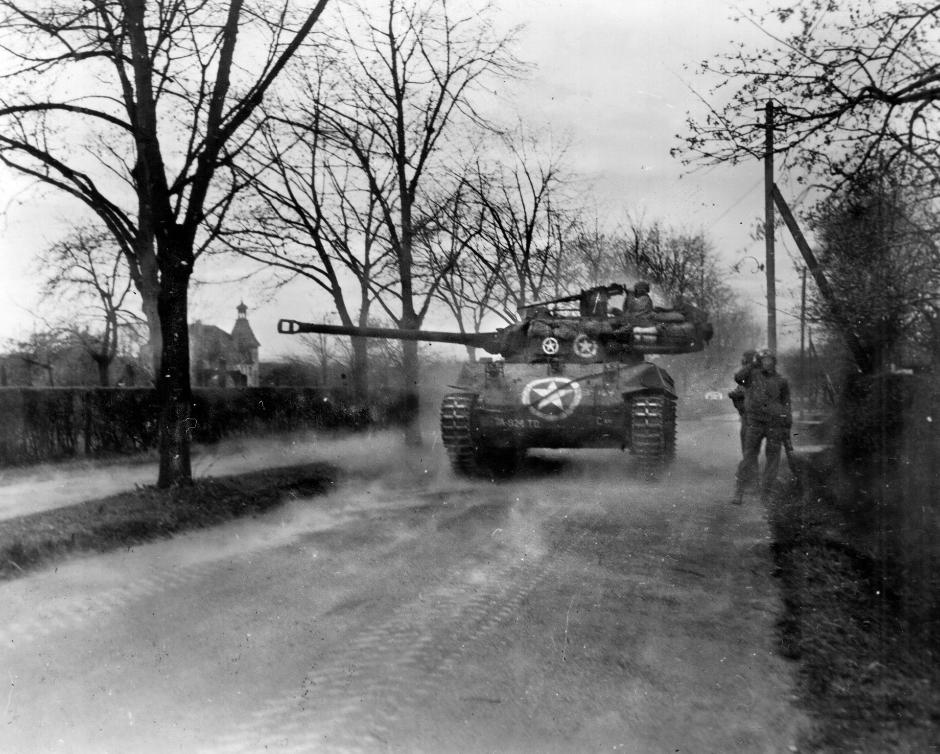 A M18 Hellcat from the 824th TD Battalion blasts German positions near Wiesloch, Germany. The M18 was faster, but lightly armored and some TD units preferred the heavier armor on the M10. 