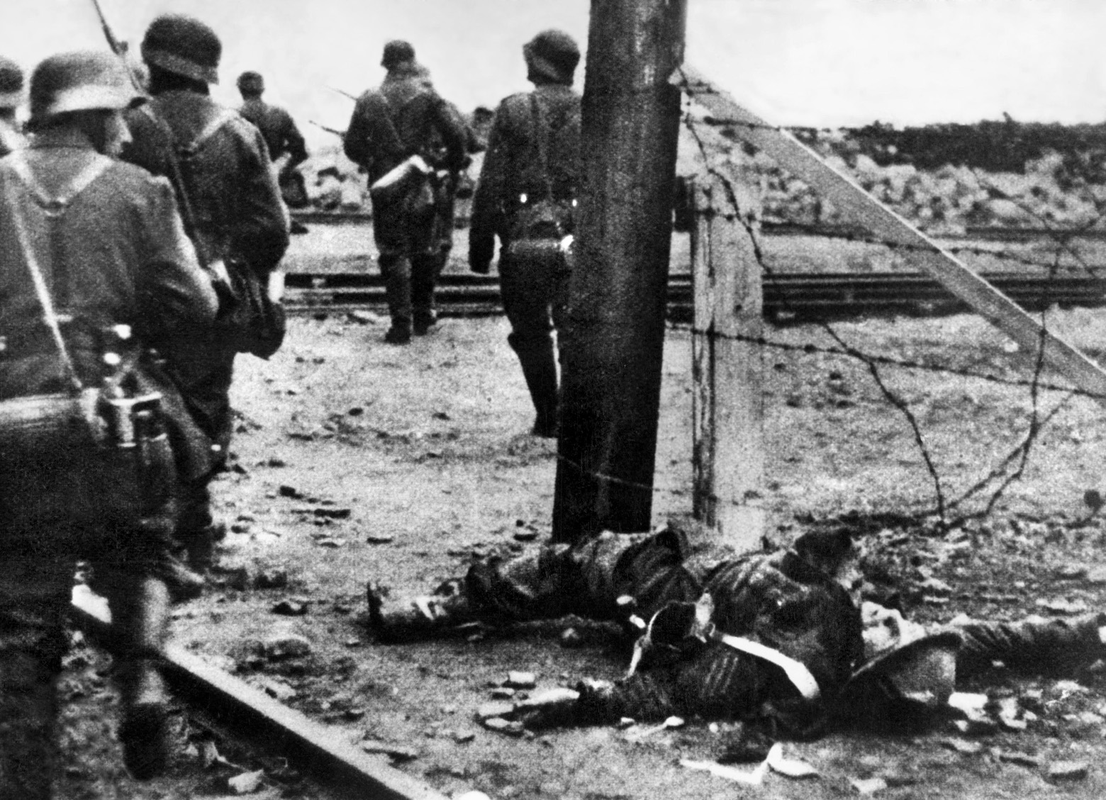 German soldiers looking for British commandos pass the lifeless body of one St. Nazaire raider who did not return home.