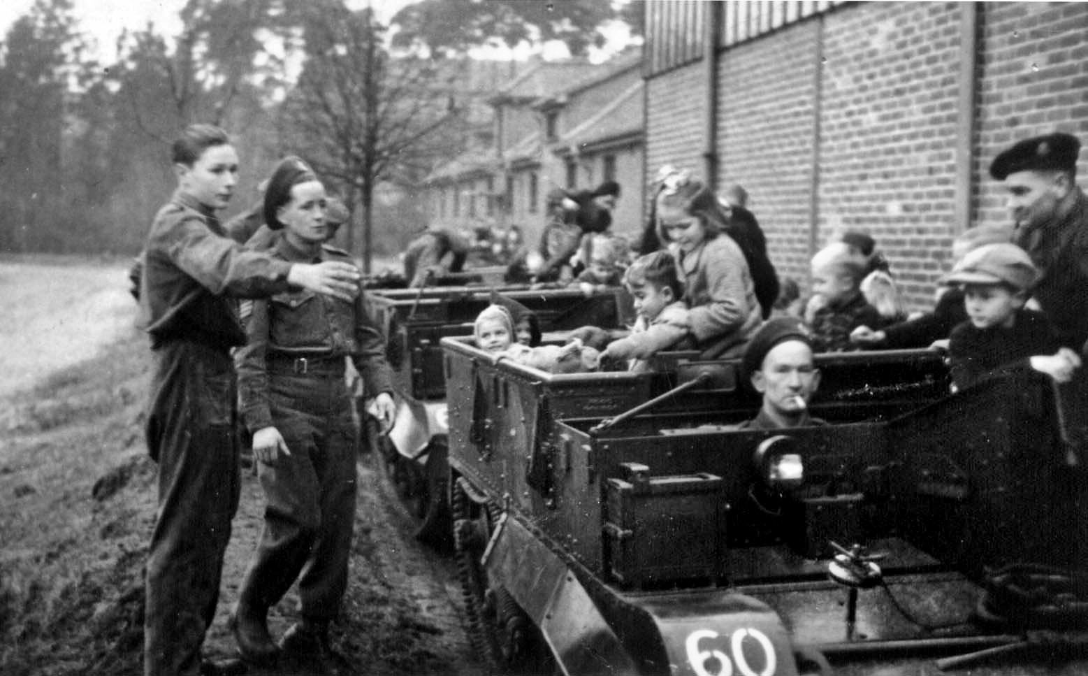 As the war was winding down, Gunther, who was fluent in English, went to work as a translator for the British occupation forces. Here he (left) directs the loading of German children into British Bren carriers at Soltau during “Fraternization Day” with members of the Hampshire Regiment.