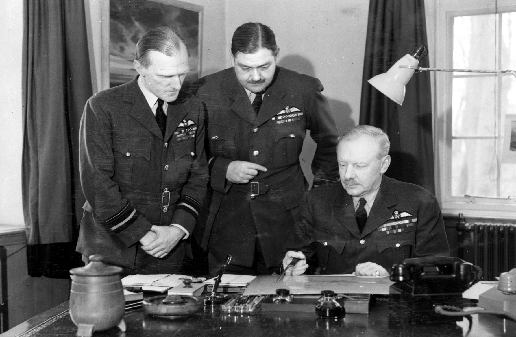 Sir Arthur “Bomber” Harris (right) with members of his RAF Bomber Command staff. Harris believed strongly that aerial bombing alone would save Allied lives, make invasion unnecessary, and win the war. 