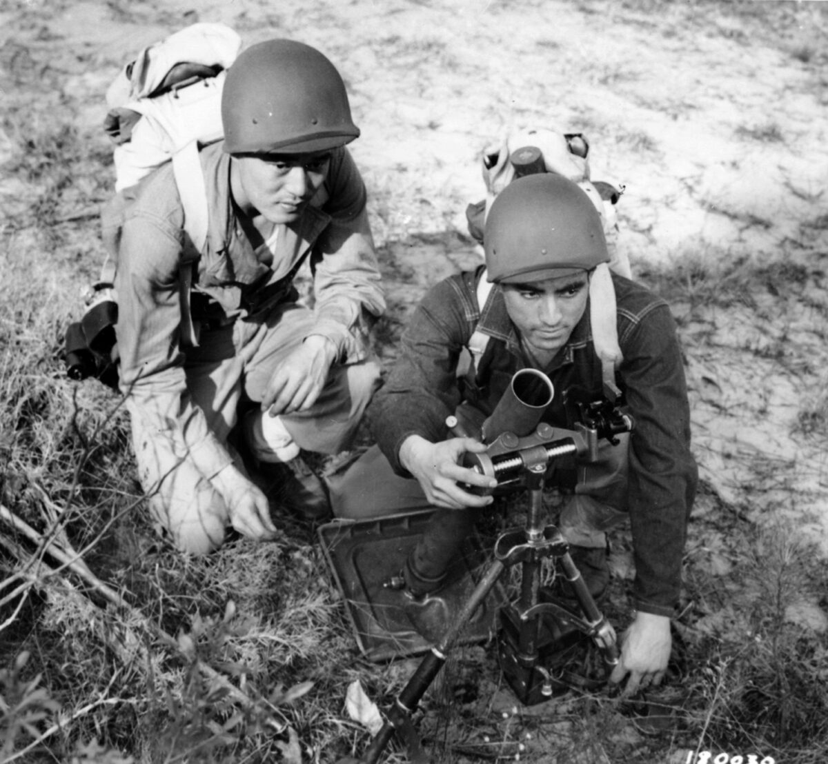 Robert Shimada and Jinichi Miyashiro, members of the 100th Infantry Battalion, set up a 60mm mortar during stateside training at Camp Shelby, Mississippi, in 1943. 