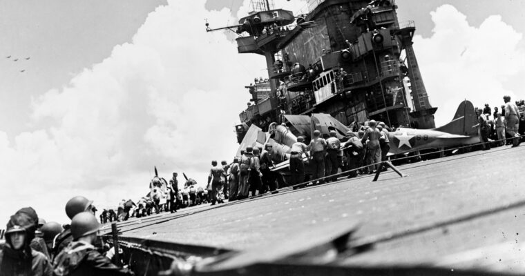 Plane-handling crews aboard USS Enterprise (CV-6) work to prepare an F4F Wildcat for flight during the Battle of the Santa Cruz Islands, October 26, 1942. The “Big E” would survive the war. Although the battle was a short-term victory for the Japanese in terms of ships sunk and damaged, Japan’s loss of many irreplaceable aircrews—particularly flight leaders—proved to be a long-term strategic advantage for the Allies in the Pacific.