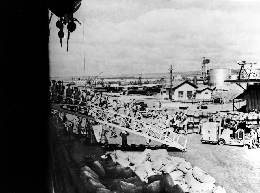 U.S. Marines board the seaplane tender USS Tangier (AV-8) at Pearl Harbor in preparation for sailing to Wake Island, December 15, 1941. The 14-ship relief force, however, was ordered to return before it reached Wake.