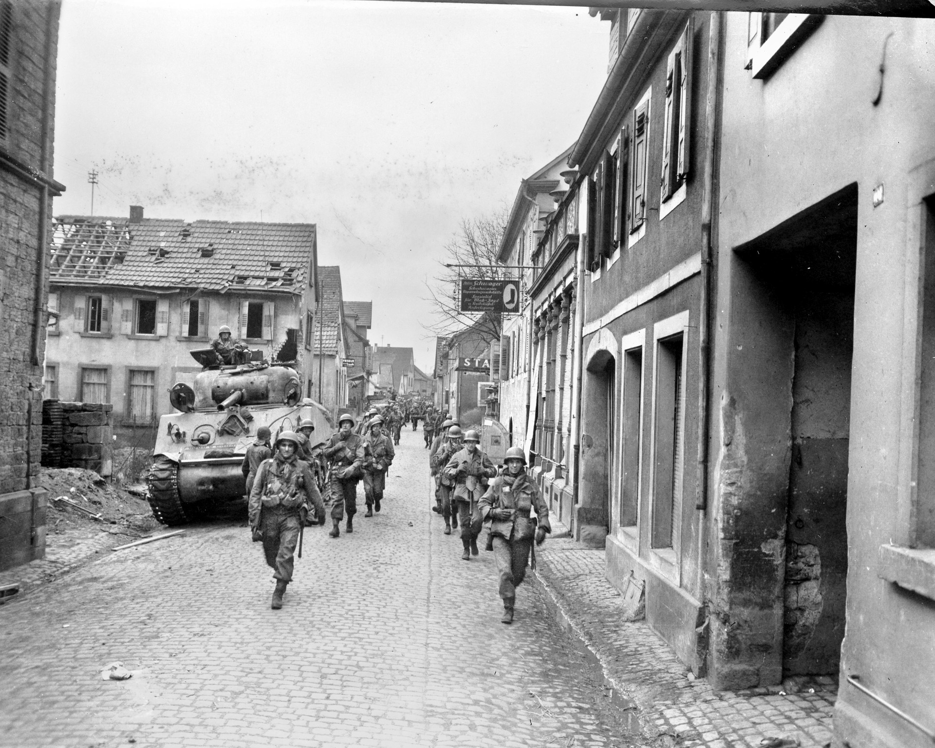 Tanks and men of the 10th Armored Division make their way through the city of Kaiserslautern in the Palatinate region of southwest Germany.