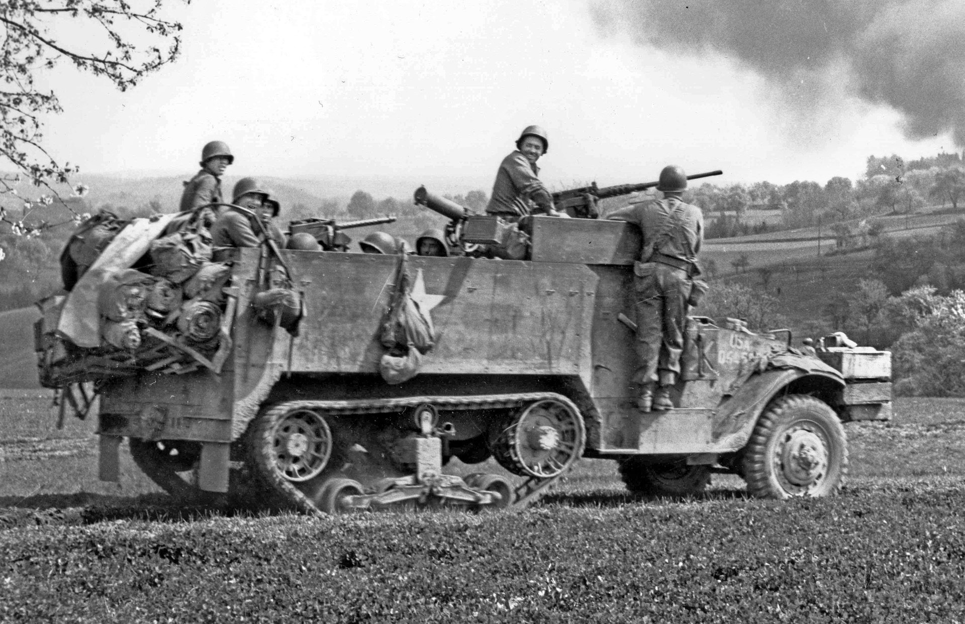 Working in tandem with the tanks, an M3 halftrack of the 61st Armored Infantry Battalion packed with soldiers and their weapons rolls toward Geisselhardt, April 1945. The war would be over in less than a month.