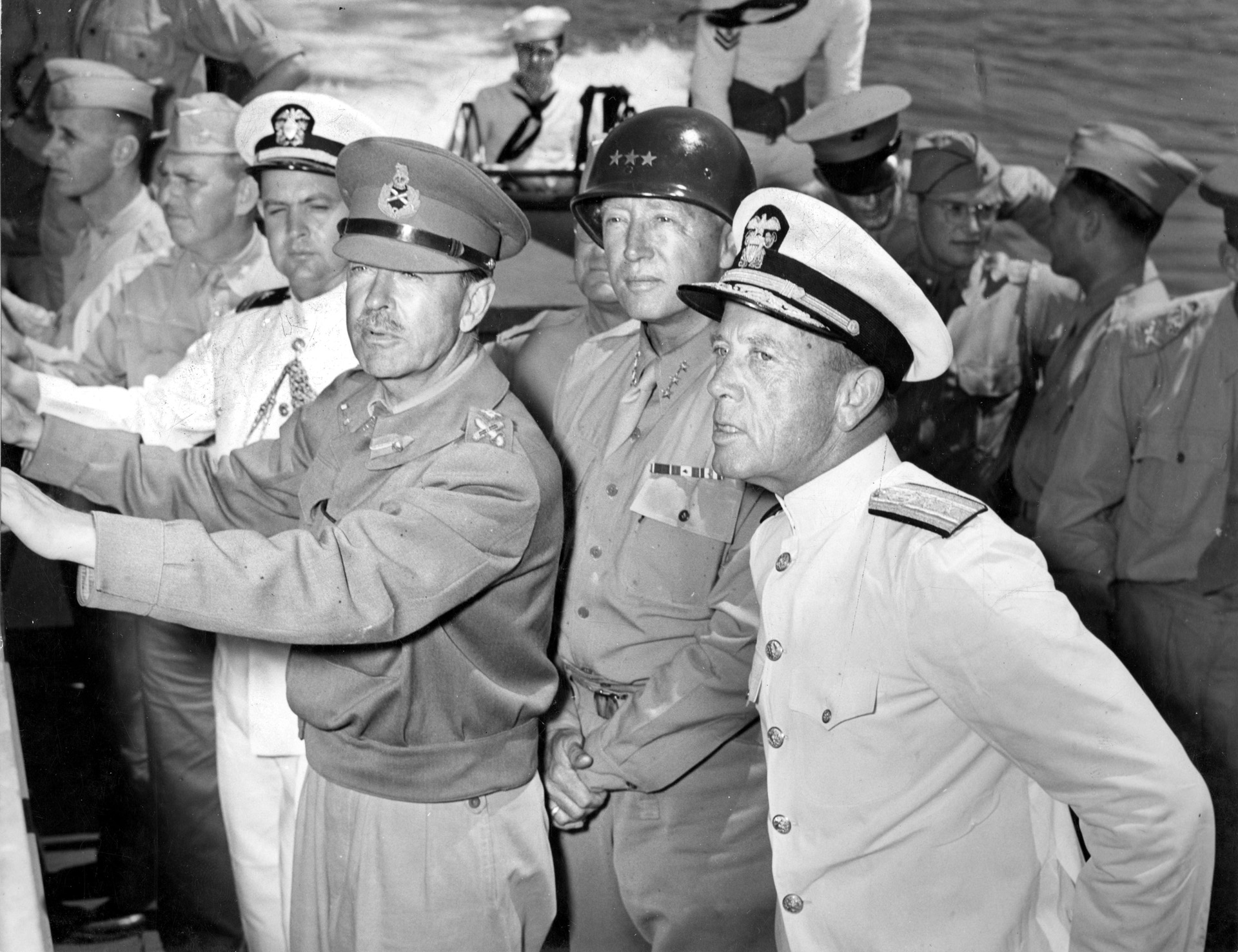 Onboard the USS Ancon, British Field Marshal Harold Alexander, the 15th Army Group commander (left), reviews the attack plan with Patton (center) and U.S. Admiral Alan Kirk (left), the amphibious force commander.